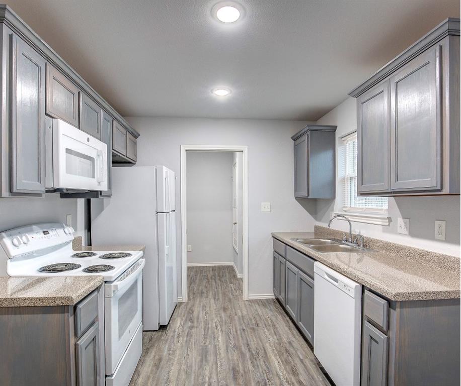 800 Sycamore Street Commerce, TX 75428 - Photo 1 of 8 a kitchen with a sink stove and cabinets
