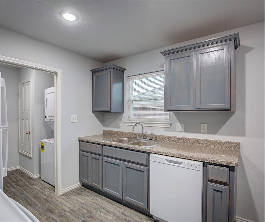 800 Sycamore Street Commerce, TX 75428 - Photo 3 of 8 a kitchen with a sink cabinets and wooden floor