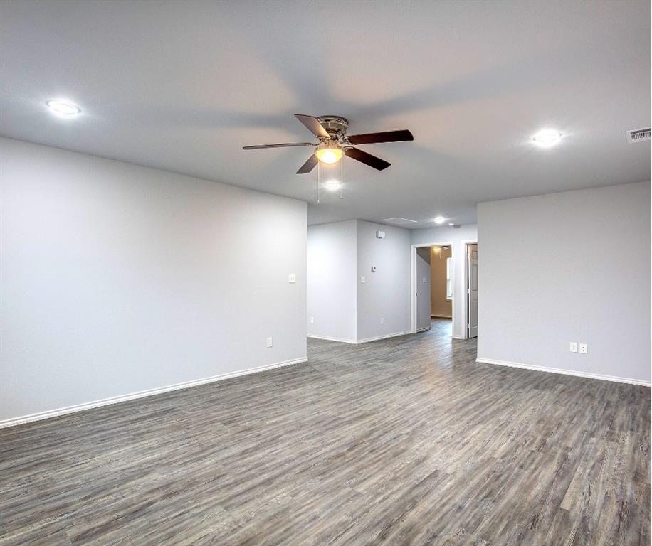 800 Sycamore Street Commerce, TX 75428 - Photo 4 of 8 a view of an empty room with window and wooden floor
