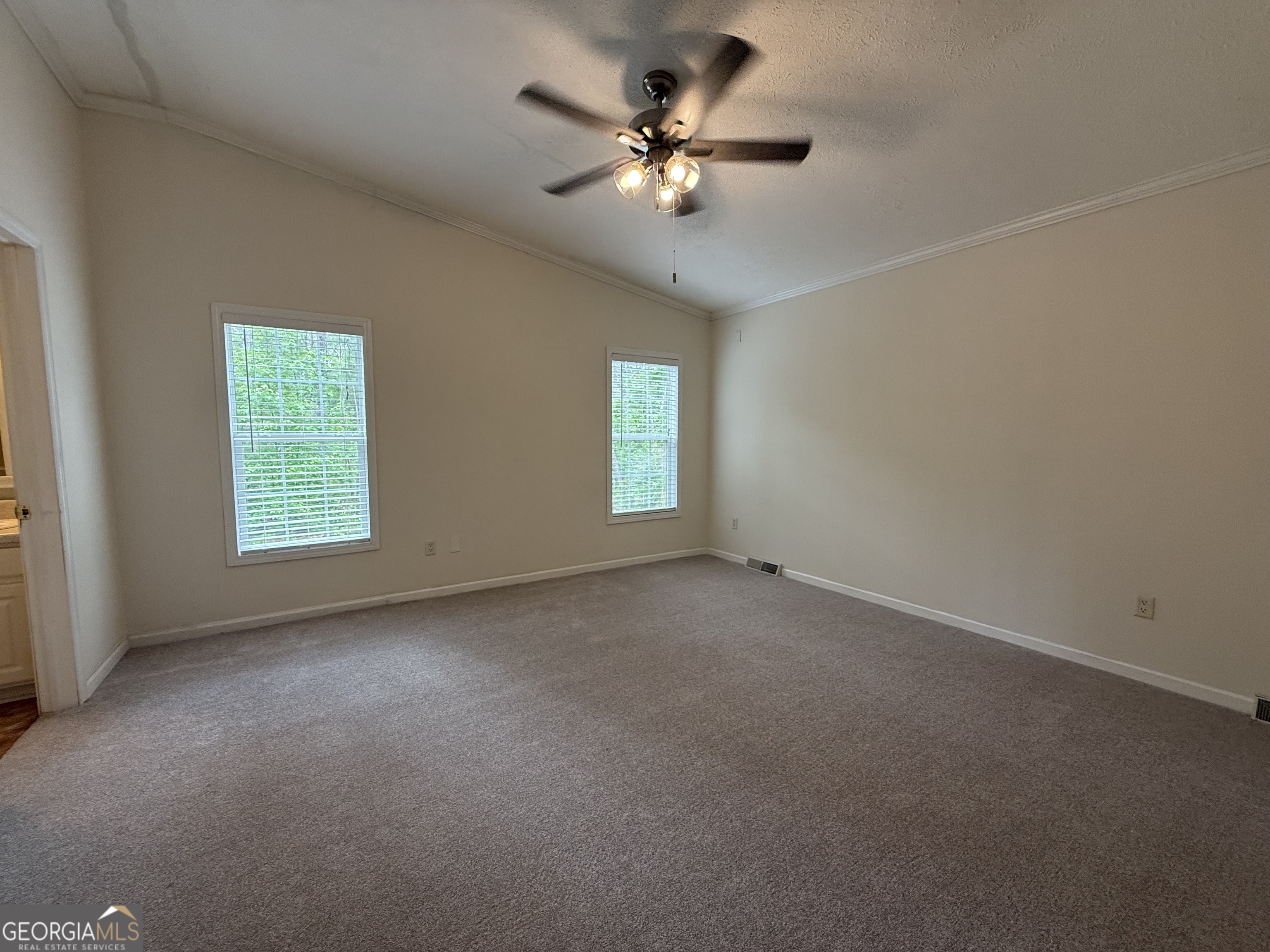 1081 Marshall Church Road Thomson, GA 30824 - Photo 16 of 26 an empty room with windows and fan