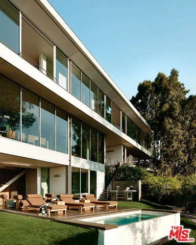 a front view of houses with yard