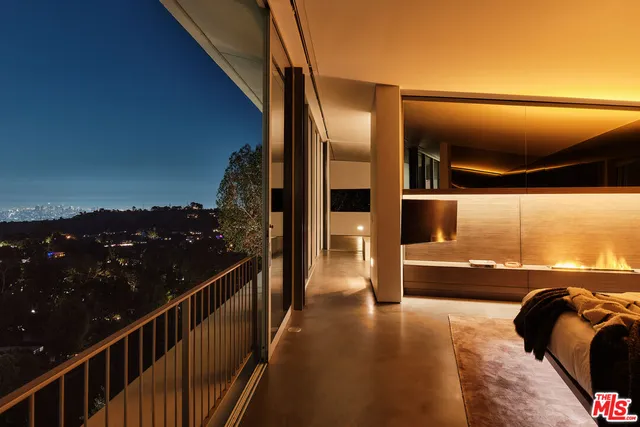 a living room with couches a dining table and chairs with outer view