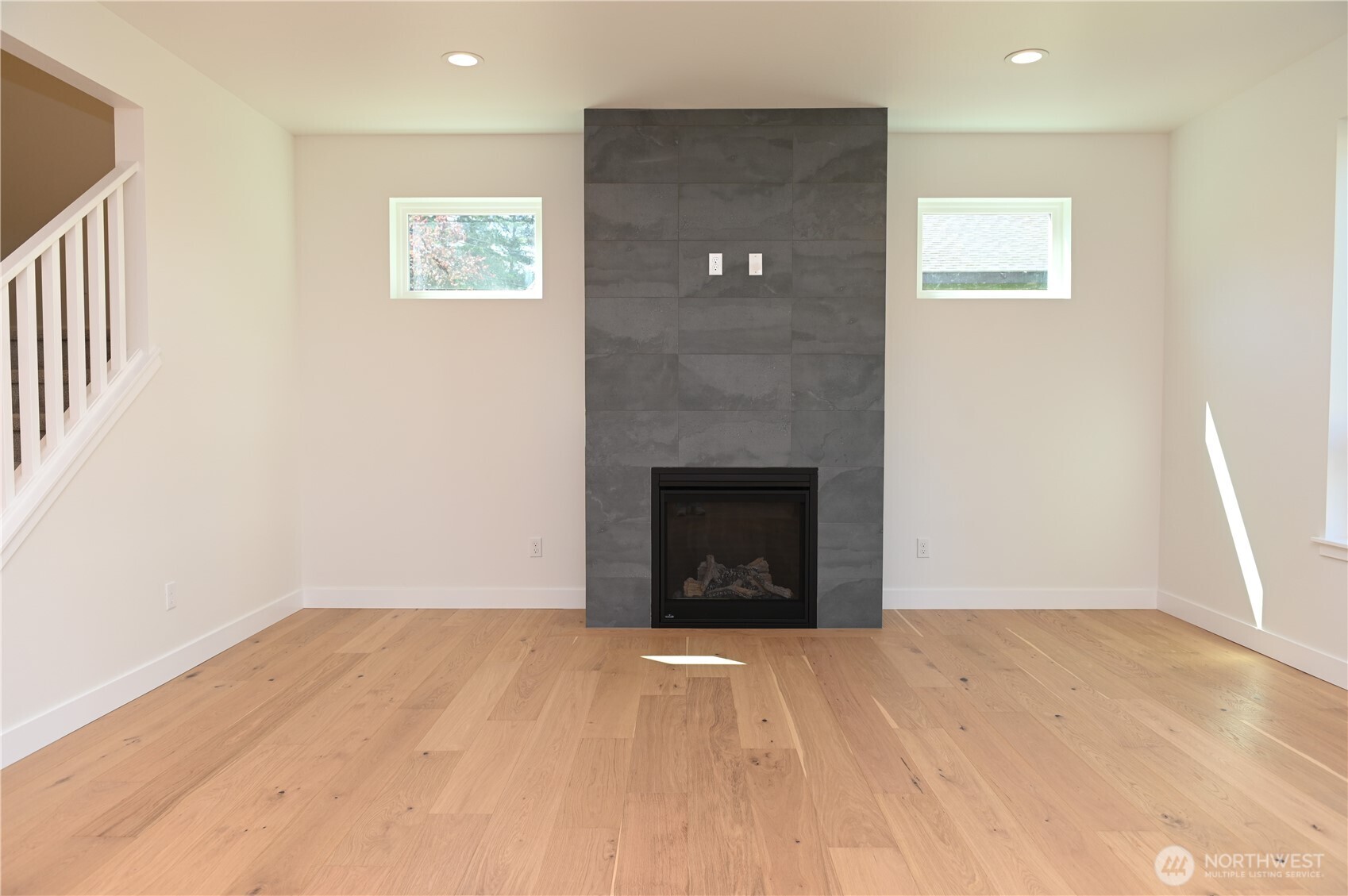 1323 Roland Street Bellingham, WA 98229 - Photo 5 of 16 a view of empty room with wooden floor and fireplace