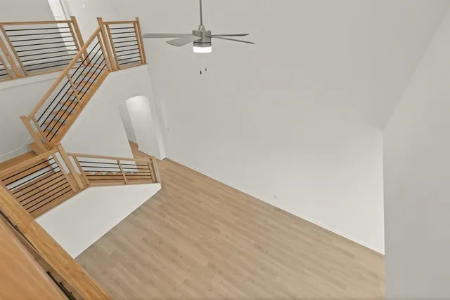 a view of a room with wooden floor