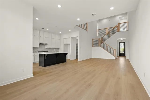 a view of kitchen with kitchen island white cabinets and stainless steel appliances