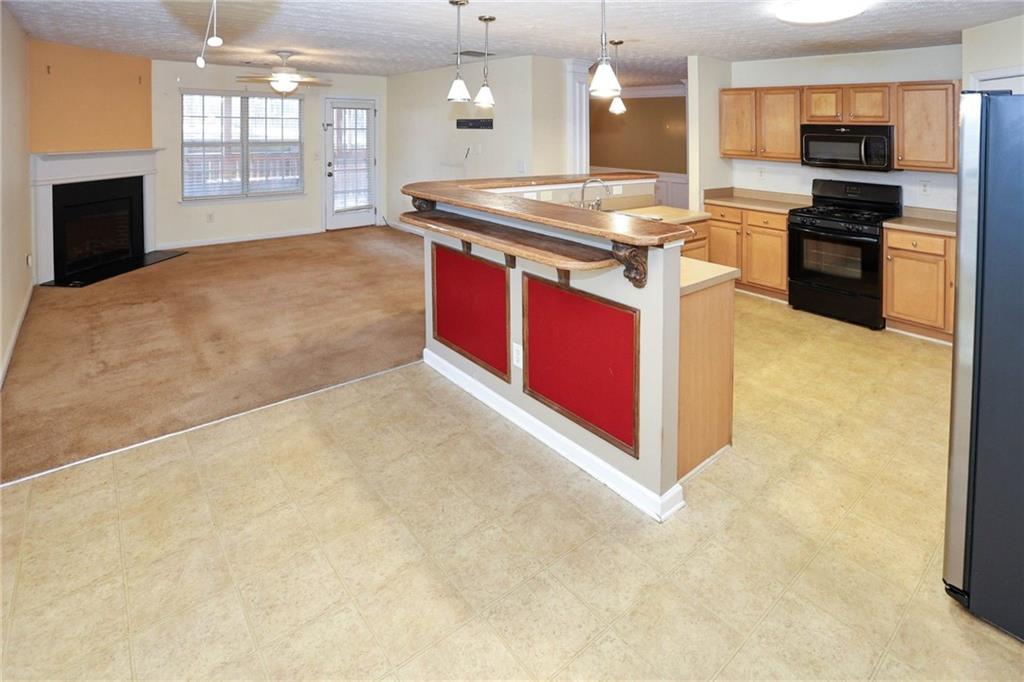 30 Emerson Trail Covington, GA 30016 - Photo 12 of 40 a kitchen with stainless steel appliances granite countertop a stove a sink and a refrigerator