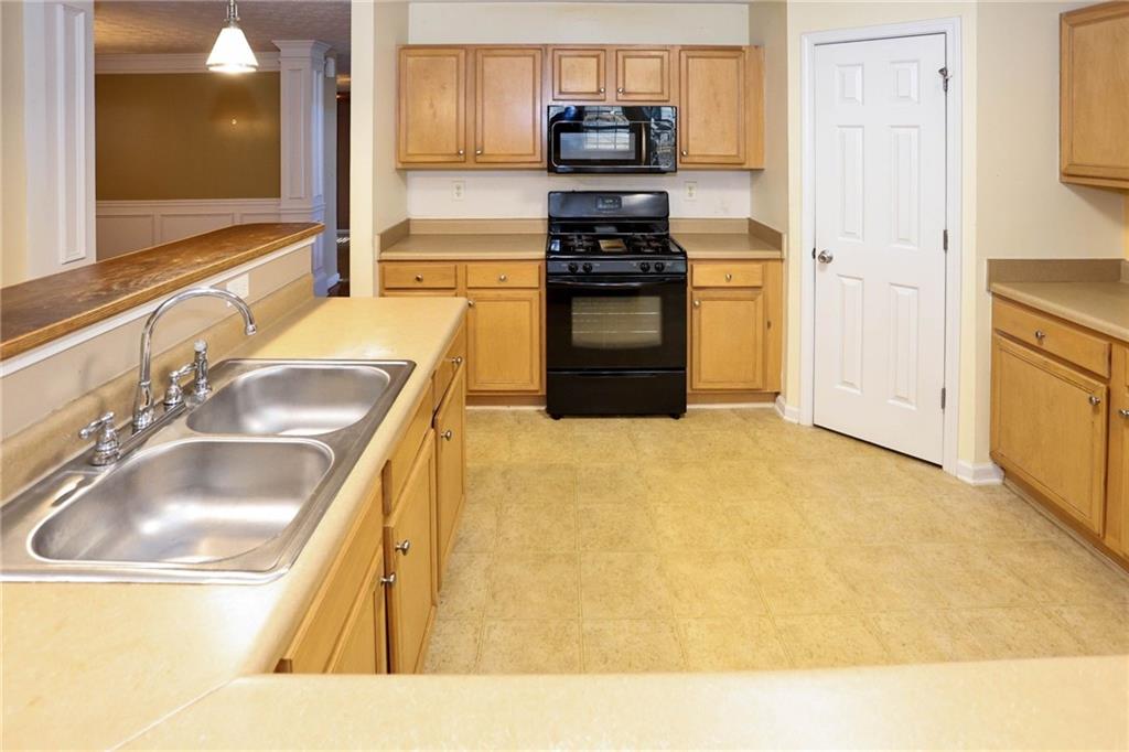 30 Emerson Trail Covington, GA 30016 - Photo 14 of 40 a kitchen with stainless steel appliances granite countertop a sink and a refrigerator