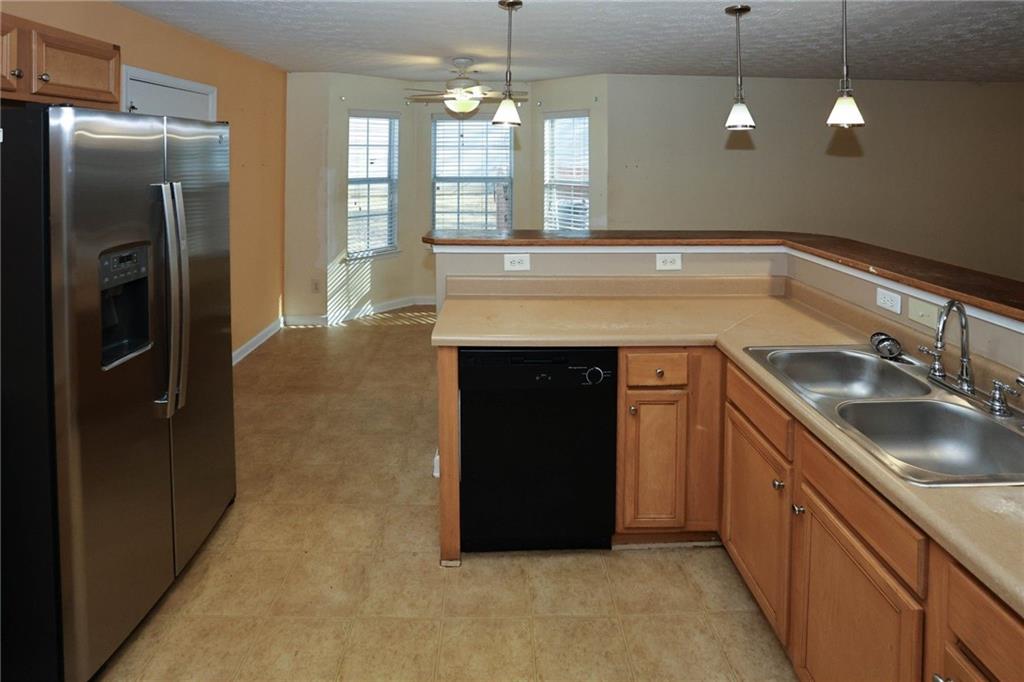 30 Emerson Trail Covington, GA 30016 - Photo 15 of 40 a kitchen with a sink and refrigerator