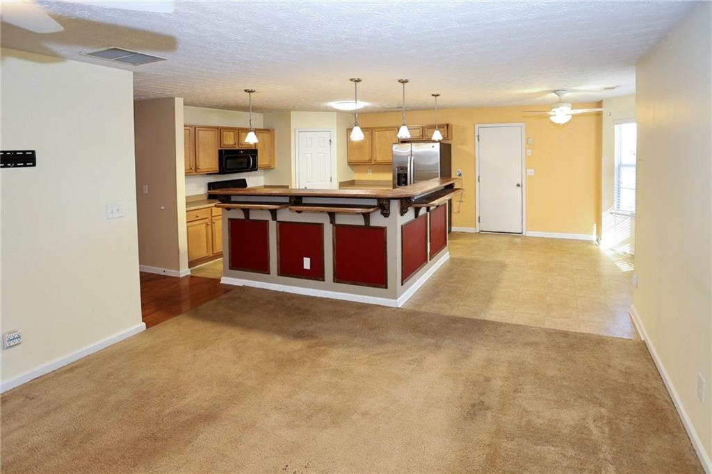 30 Emerson Trail Covington, GA 30016 - Photo 18 of 40 a large kitchen with stainless steel appliances kitchen island granite countertop a refrigerator a stove a sink and a oven
