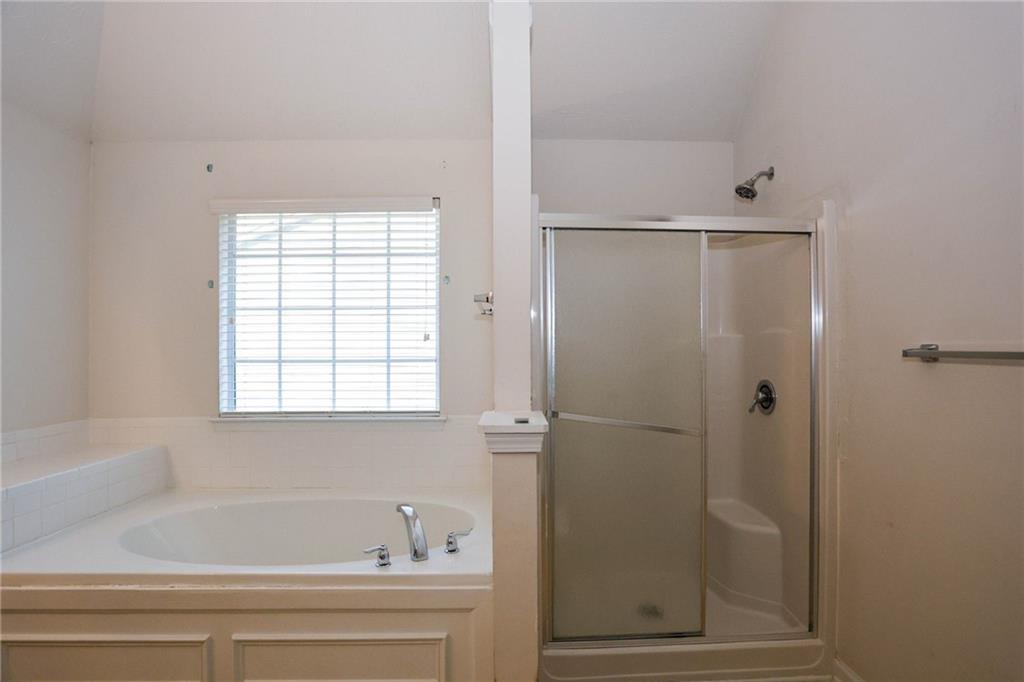 30 Emerson Trail Covington, GA 30016 - Photo 28 of 40 a bathroom with a bathtub and shower