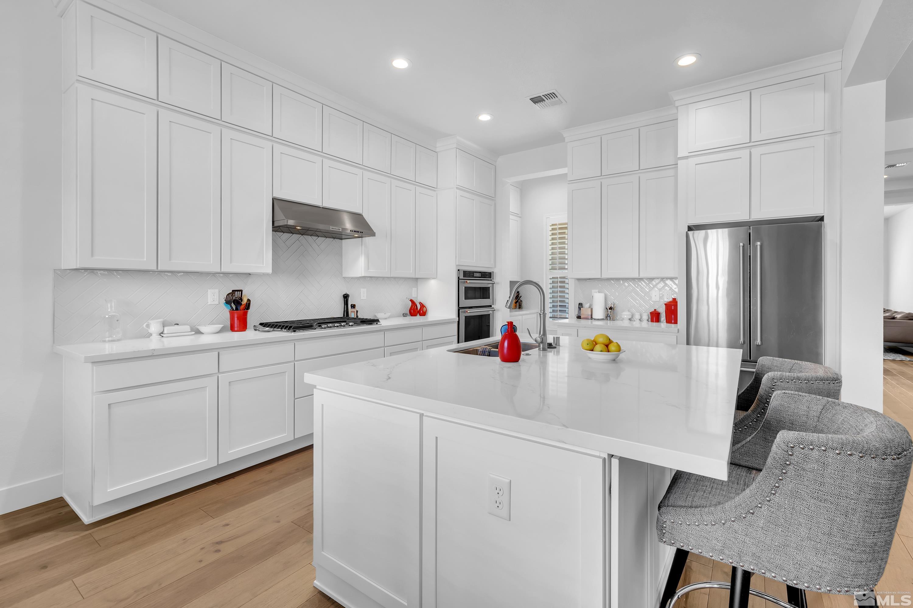 2201 Kate's Bridge Drive Reno, NV 89521 - Photo 11 of 39 a kitchen with stainless steel appliances white cabinets and a refrigerator