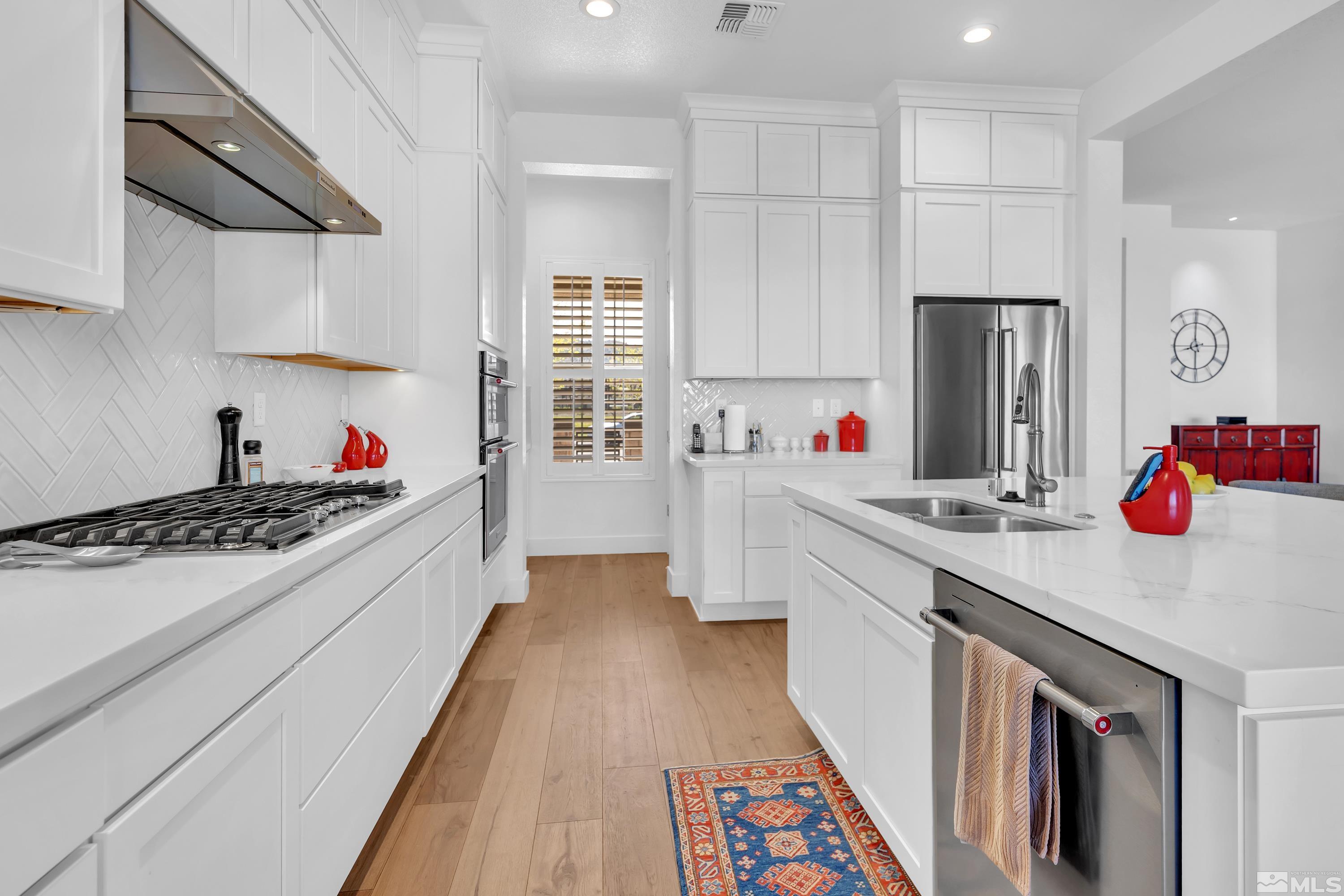 2201 Kate's Bridge Drive Reno, NV 89521 - Photo 14 of 39 a kitchen with kitchen island wooden cabinets and stainless steel appliances