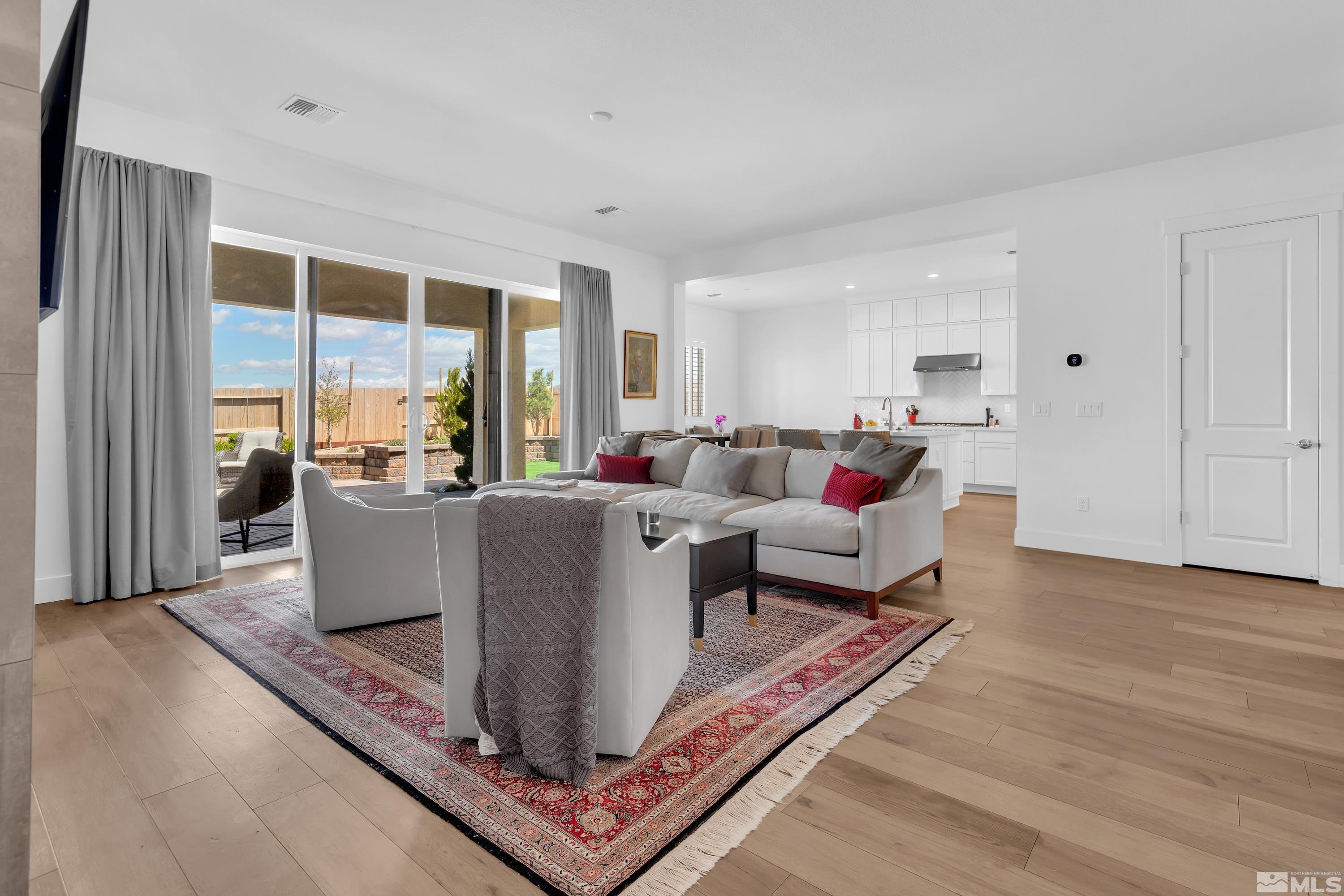 2201 Kate's Bridge Drive Reno, NV 89521 - Photo 18 of 39 a living room with furniture a large window and a rug