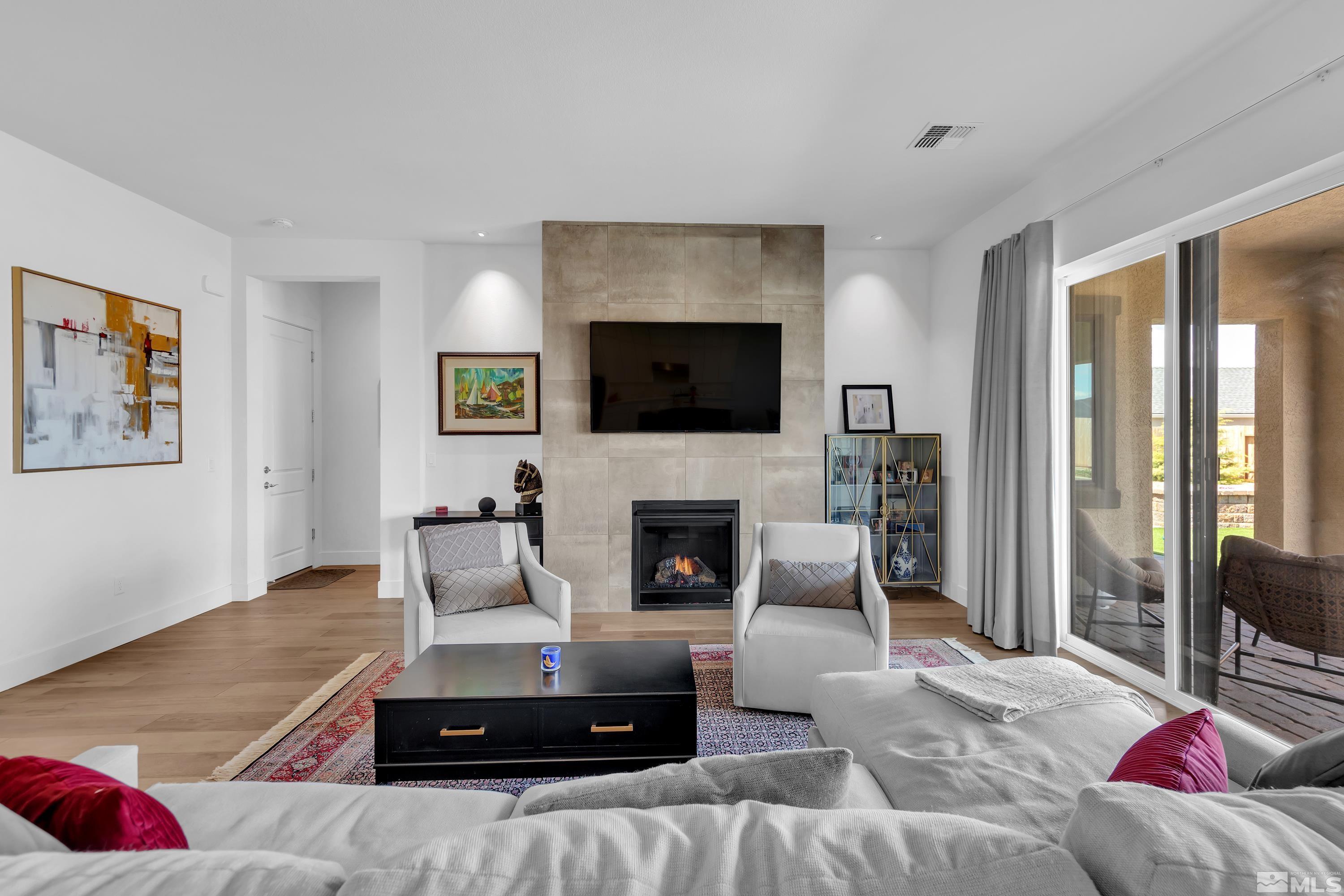 2201 Kate's Bridge Drive Reno, NV 89521 - Photo 7 of 39 a living room with furniture a flat screen tv and a fireplace