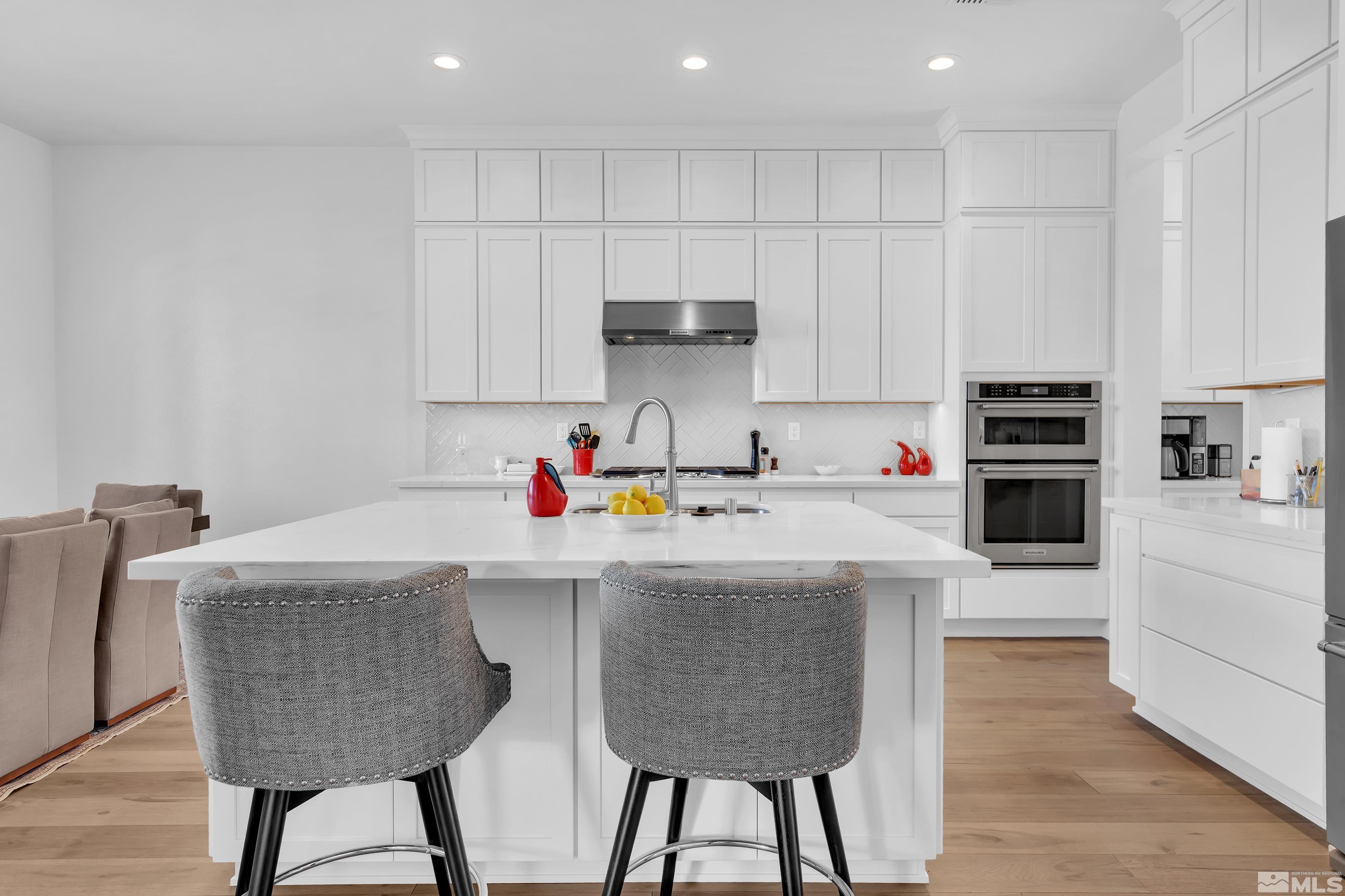 2201 Kate's Bridge Drive Reno, NV 89521 - Photo 10 of 39 a kitchen with kitchen island a stove a sink and a refrigerator