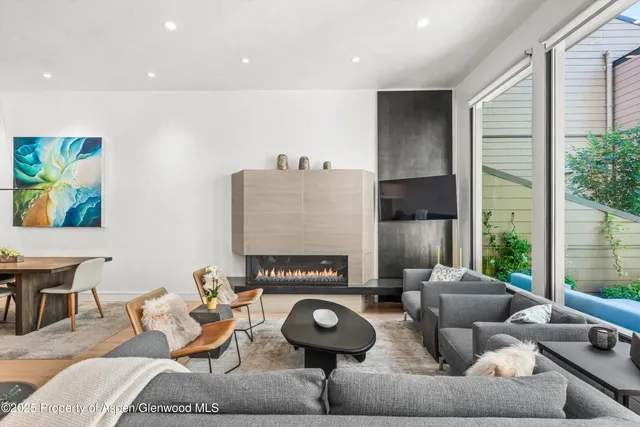 a living room with furniture and a lamp