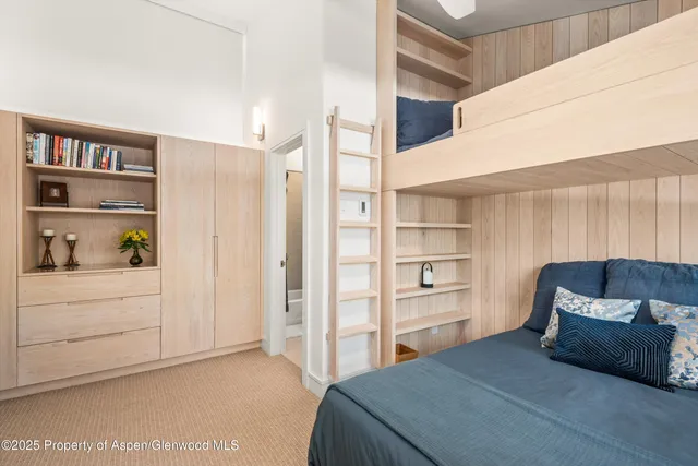 a bedroom with a bed and cabinets