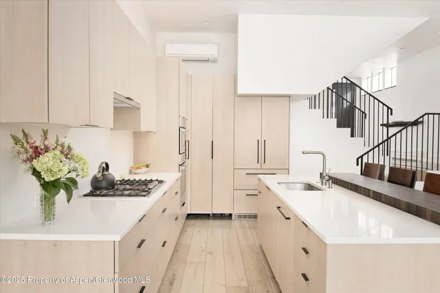 a kitchen with a sink stove and cabinets