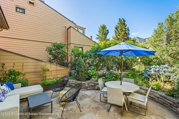 a view of backyard with seating space and wooden floor