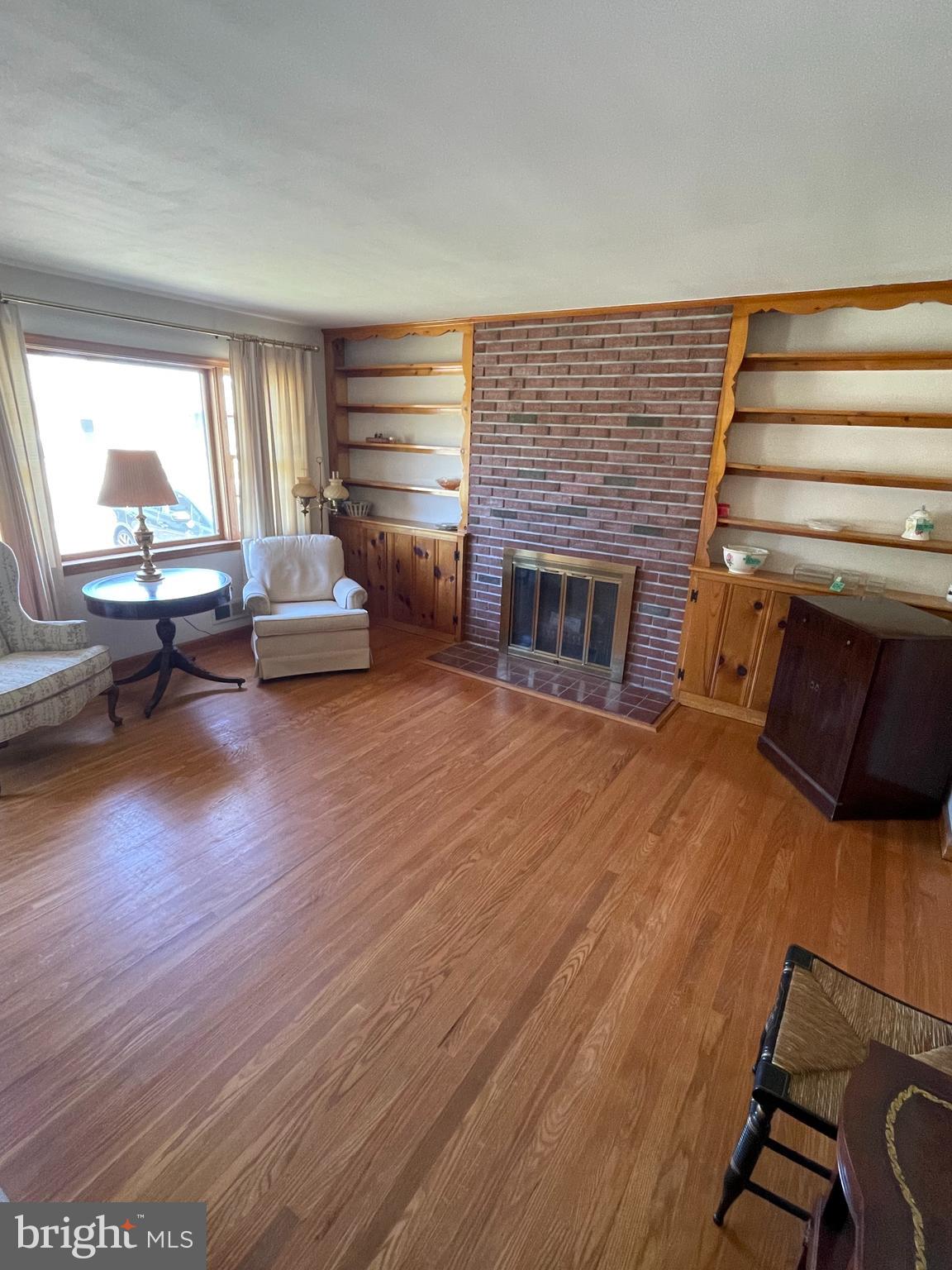 703 Juniper Road Linthicum Heights, MD 21090 - Photo 5 of 26 a living room with furniture and a fireplace