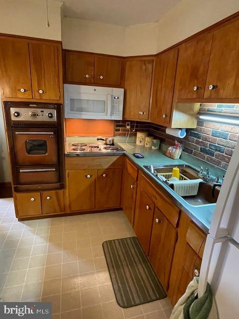 703 Juniper Road Linthicum Heights, MD 21090 - Photo 7 of 26 a kitchen with stainless steel appliances a stove a sink and a microwave