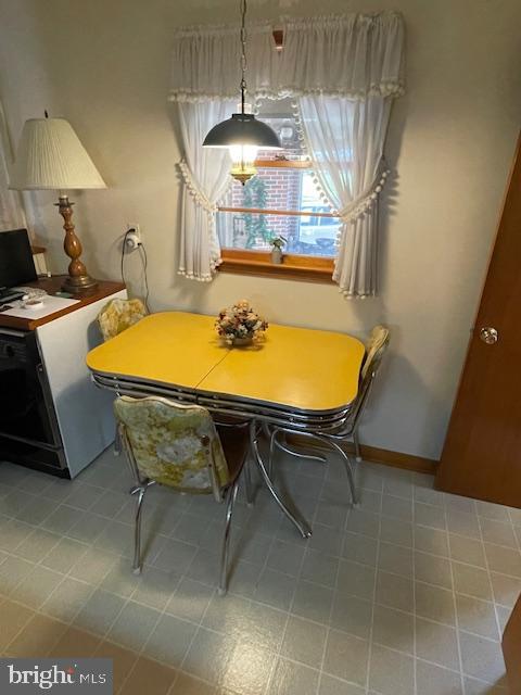 703 Juniper Road Linthicum Heights, MD 21090 - Photo 10 of 26 a view of a dining room with furniture and chandelier
