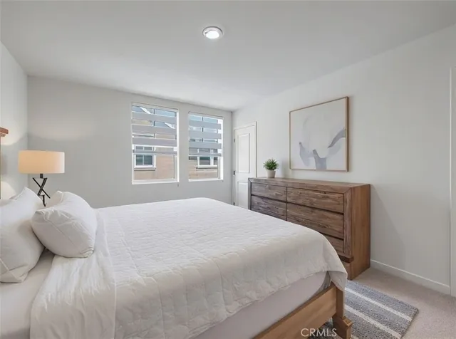 a bedroom with a large bed and a window