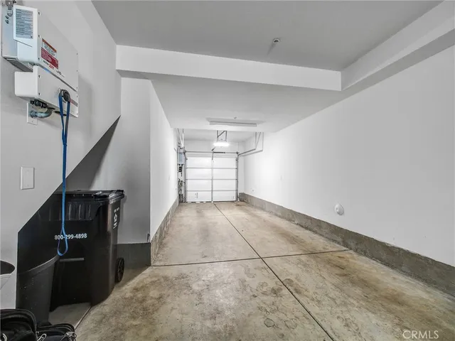 a view of a livingroom with wooden floor and stairs
