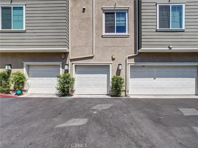 a front view of a house with a garage and a yard