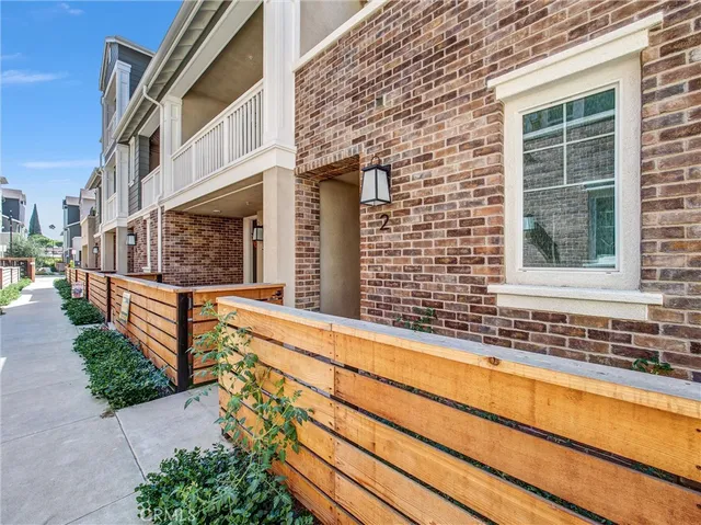 a view of a brick house with large windows