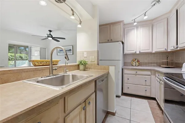 a kitchen with a sink stove and cabinets