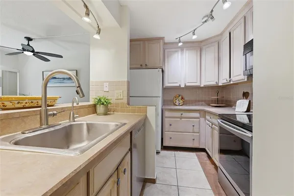 a kitchen with a sink stove and cabinets