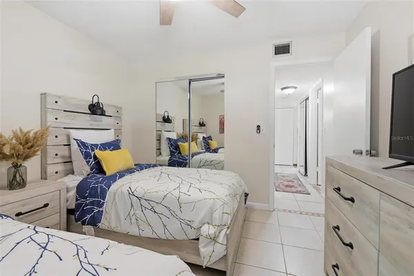 a bedroom with a large bed and a chandelier