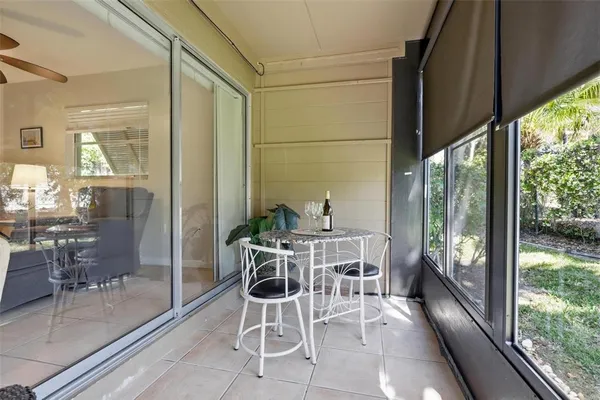 a view of a patio with chairs and a table under an umbrella
