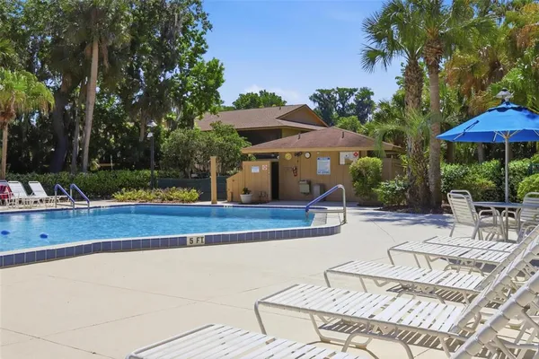 a view of a swimming pool with a patio and a garden
