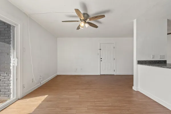a view of a kitchen with wooden floor and a sink
