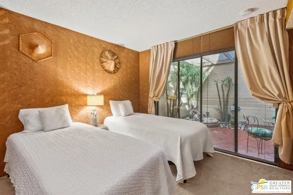 a bedroom with furniture and flat screen tv