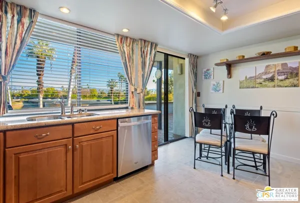 a kitchen with stainless steel appliances granite countertop a refrigerator stove and sink