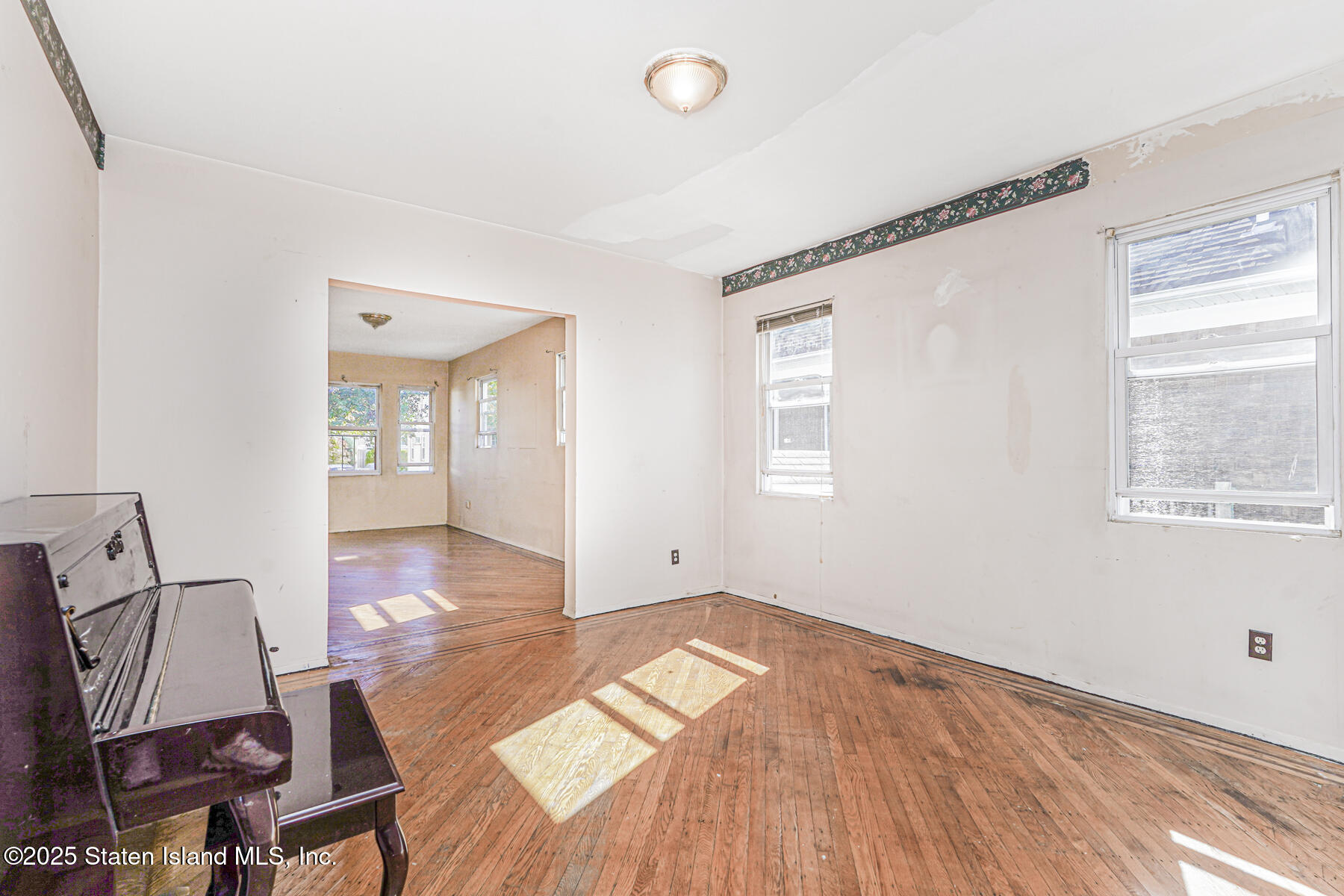252 Dickie Avenue Staten Island, NY 10314 - Photo 12 of 37 a view of a room with wooden floor and windows