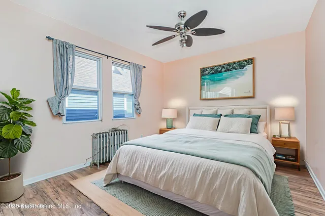 a spacious bedroom with a large bed and a potted plant