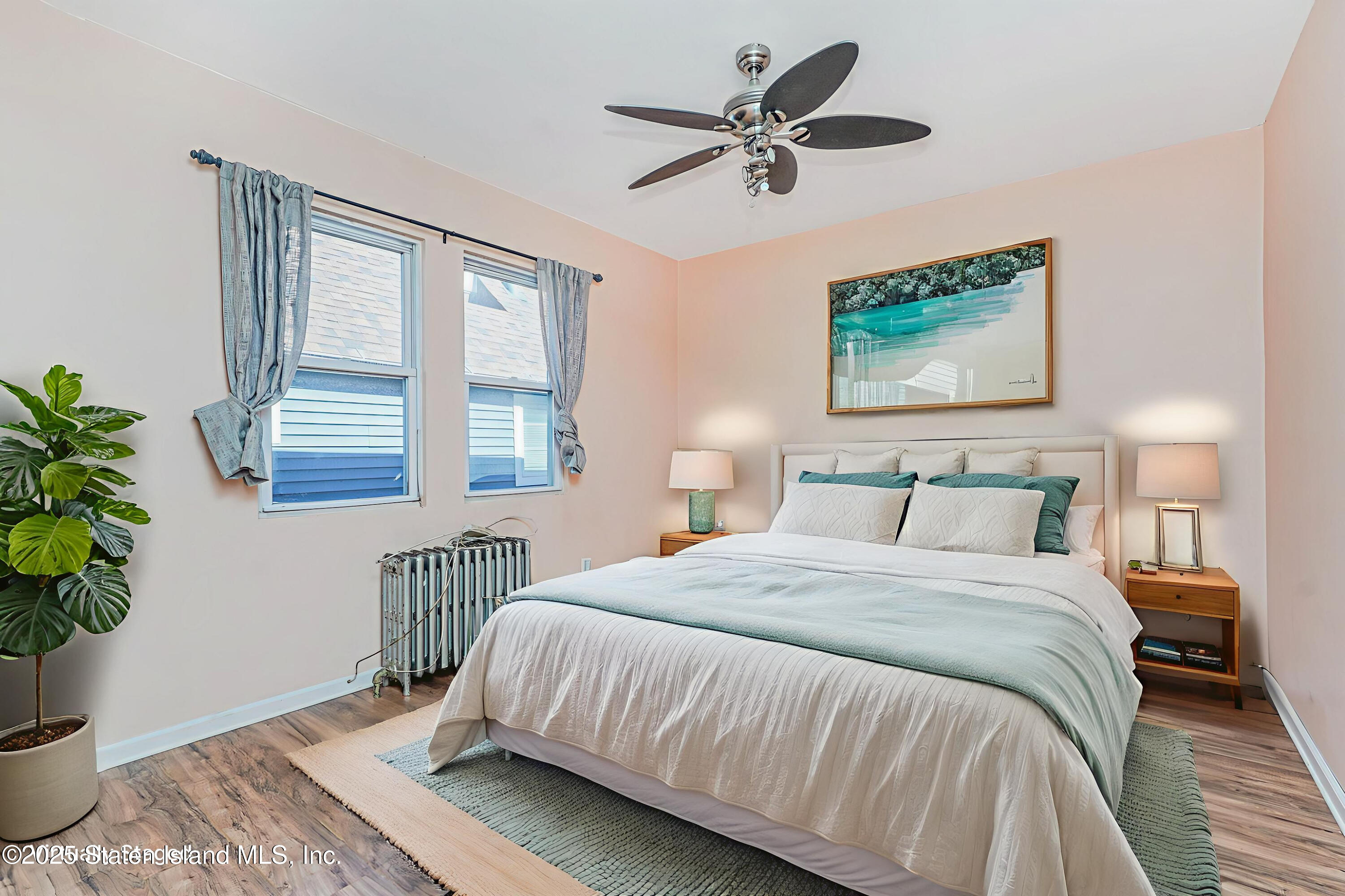 252 Dickie Avenue Staten Island, NY 10314 - Photo 14 of 37 a spacious bedroom with a large bed and a potted plant