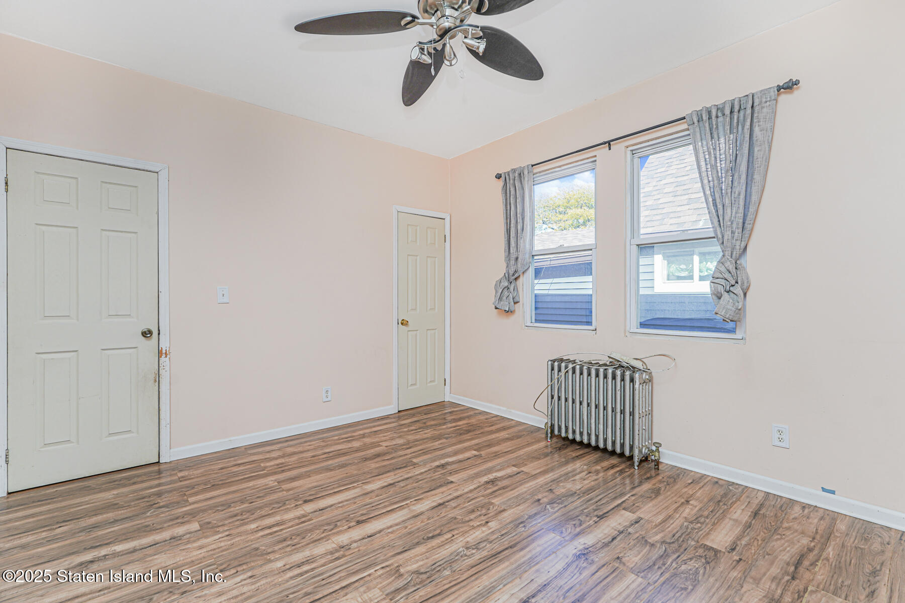 252 Dickie Avenue Staten Island, NY 10314 - Photo 16 of 37 a view of empty room with wooden floor and fan
