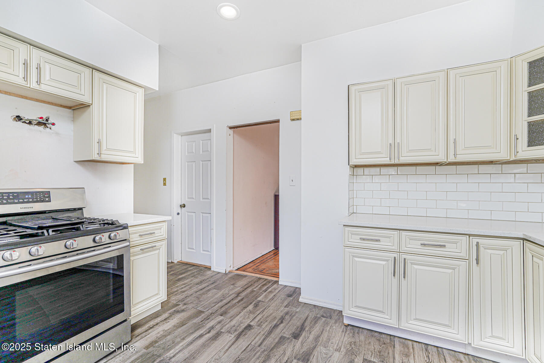 252 Dickie Avenue Staten Island, NY 10314 - Photo 20 of 37 a kitchen with white cabinets and appliances