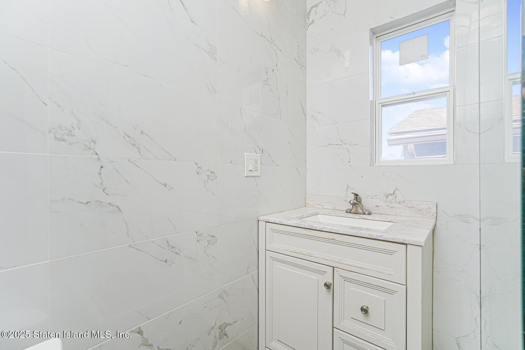 252 Dickie Avenue Staten Island, NY 10314 - Photo 23 of 37 a bathroom with a sink a vanity and a shower