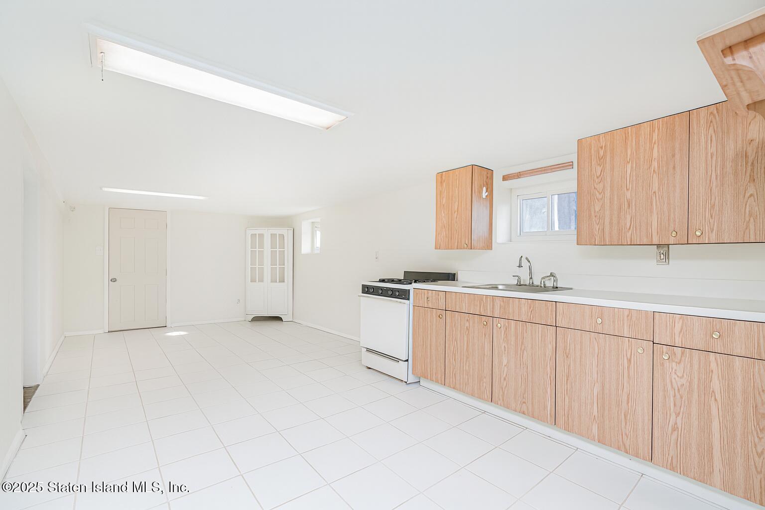 252 Dickie Avenue Staten Island, NY 10314 - Photo 28 of 37 a spacious bathroom with a double vanity sink a mirror and a bathtub