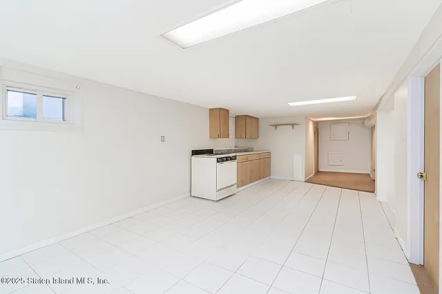 a view of a kitchen with white cabinets
