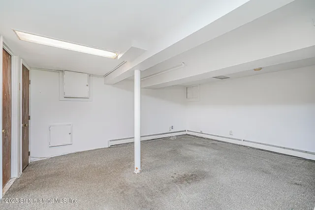 a view of backyard with large trees and wooden fence
