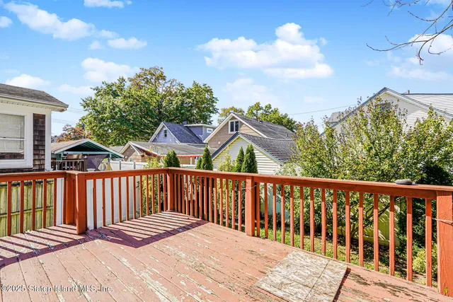 a view of backyard with a garden and deck