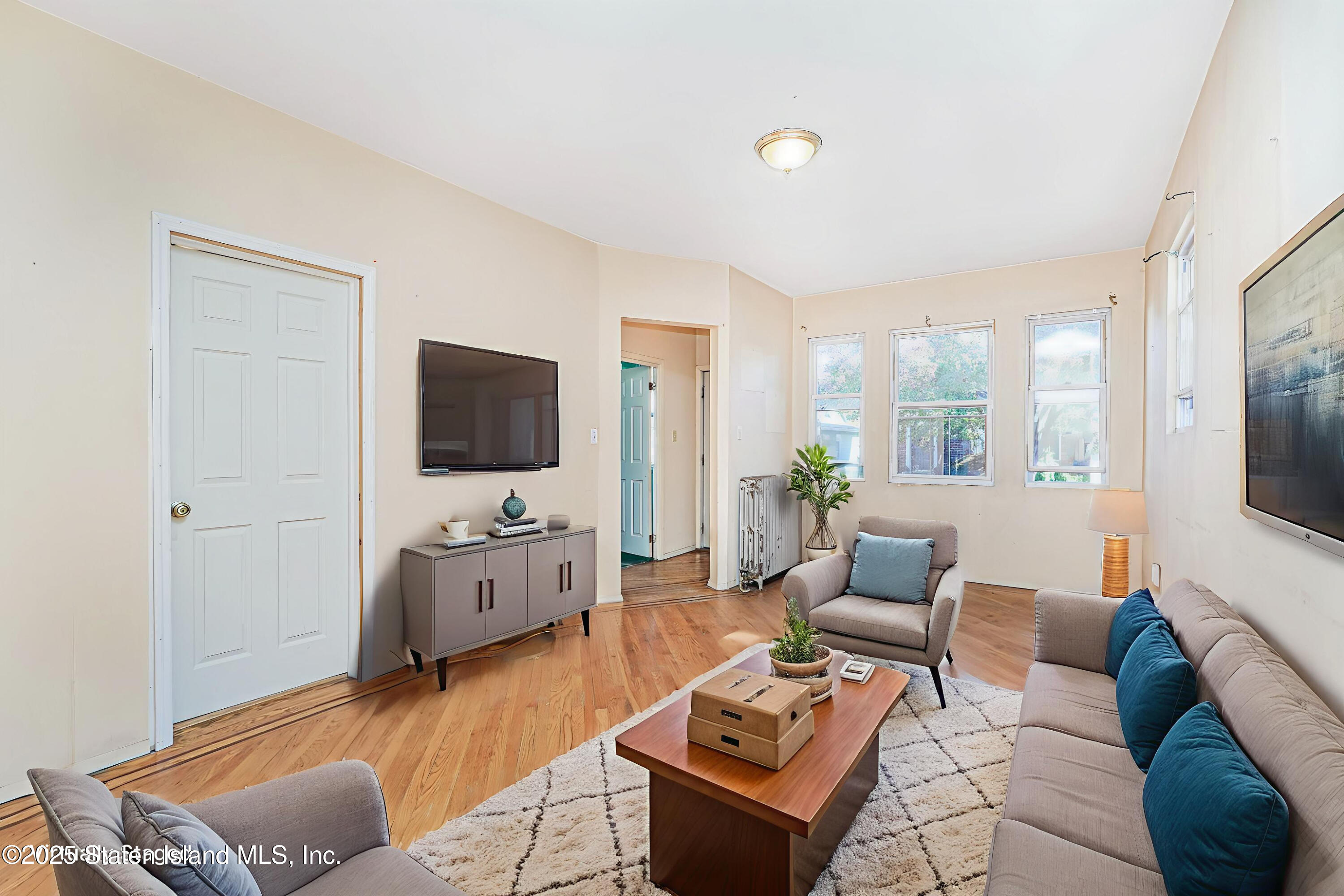 252 Dickie Avenue Staten Island, NY 10314 - Photo 4 of 37 a living room with furniture and a flat screen tv