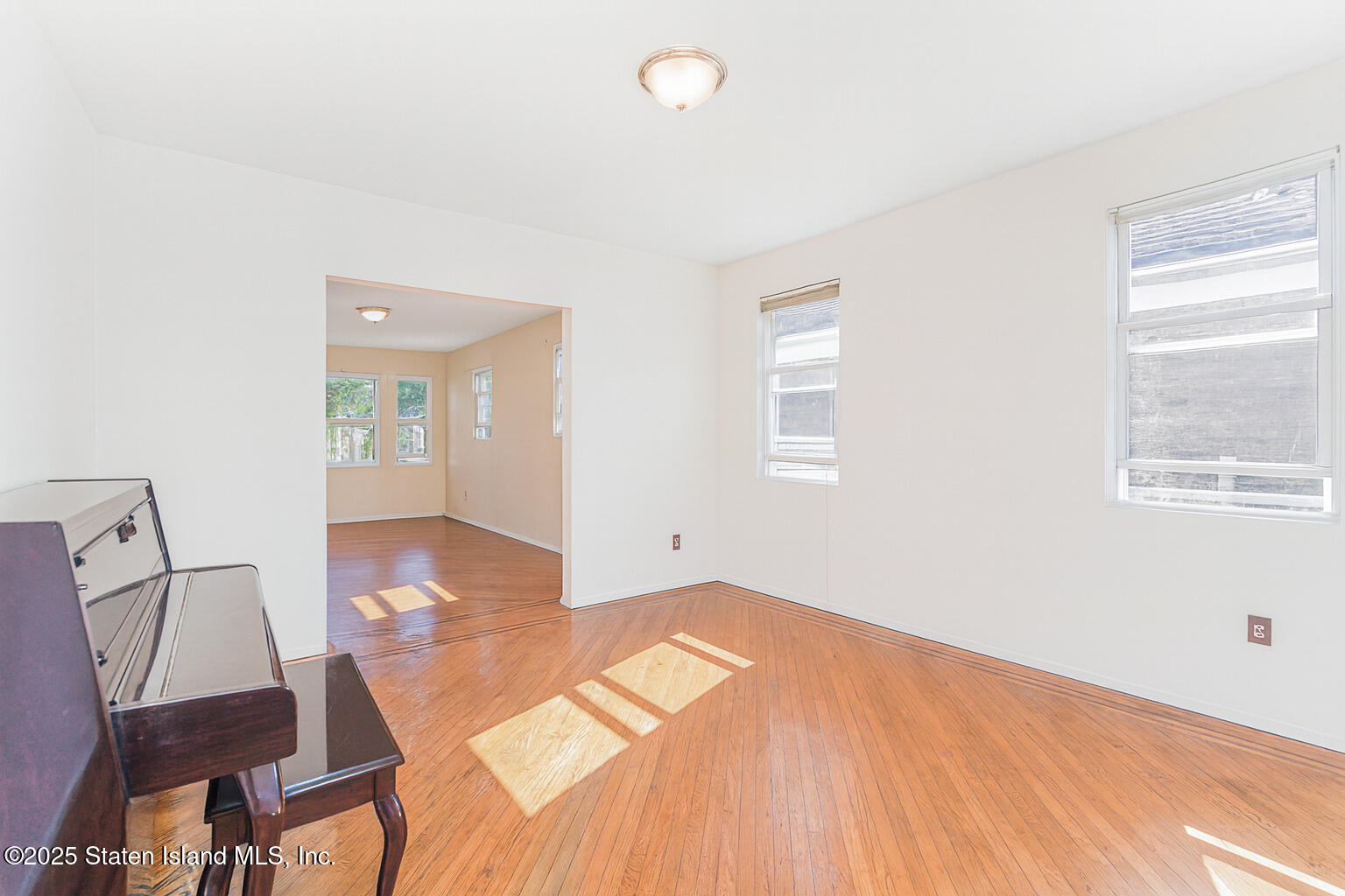 252 Dickie Avenue Staten Island, NY 10314 - Photo 6 of 37 a view of a room with wooden floor and windows